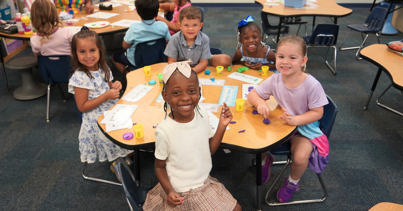 students pose while working together