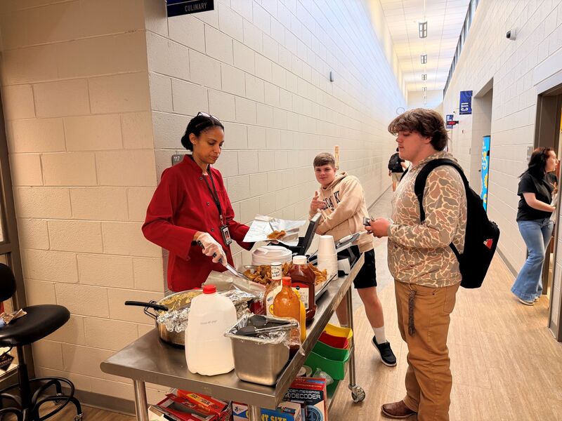 a chef dishes up fred fish to her student customers