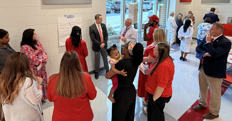 a group shares ideas for improvement which are captured on a large piece of paper