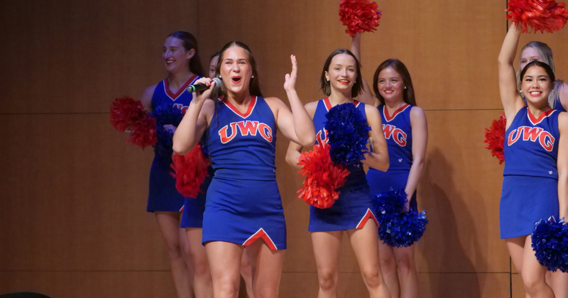 UWG cheerleaders lead a cheer on stage