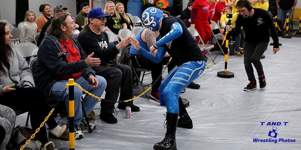 wrestler shaking hands with crowd