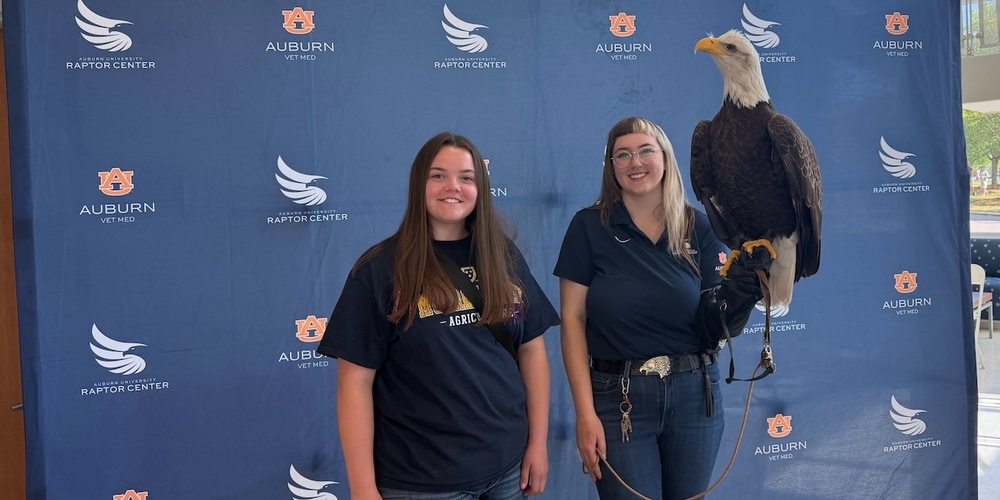 student with bald eagle