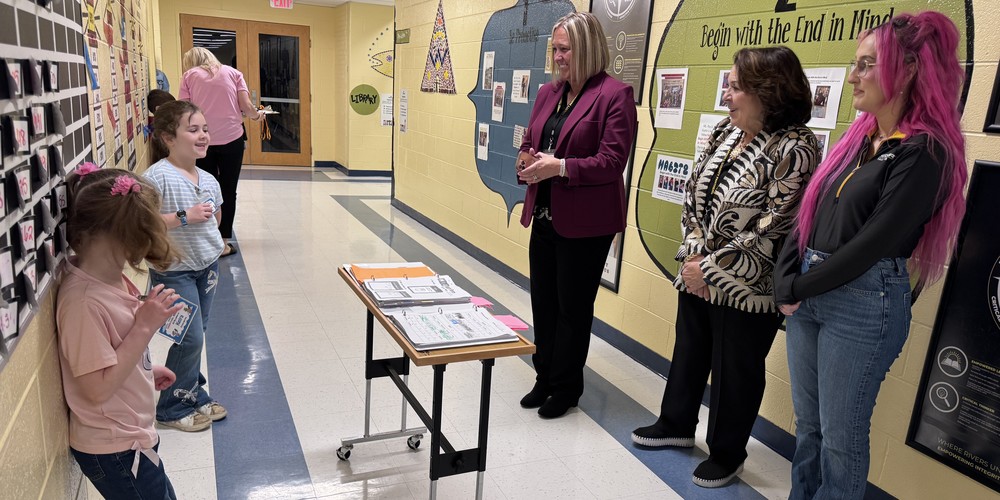 student leaders talking to adults