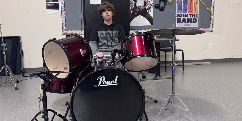 student playing drums