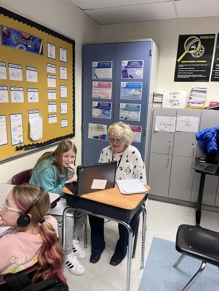 Ms. Satchwell helping in Ms. Meffords class