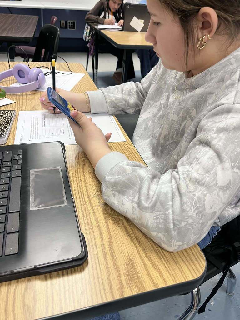 Ms. Satchwell helping in Ms. Meffords class