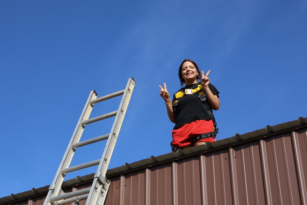 Student standing on top of roof