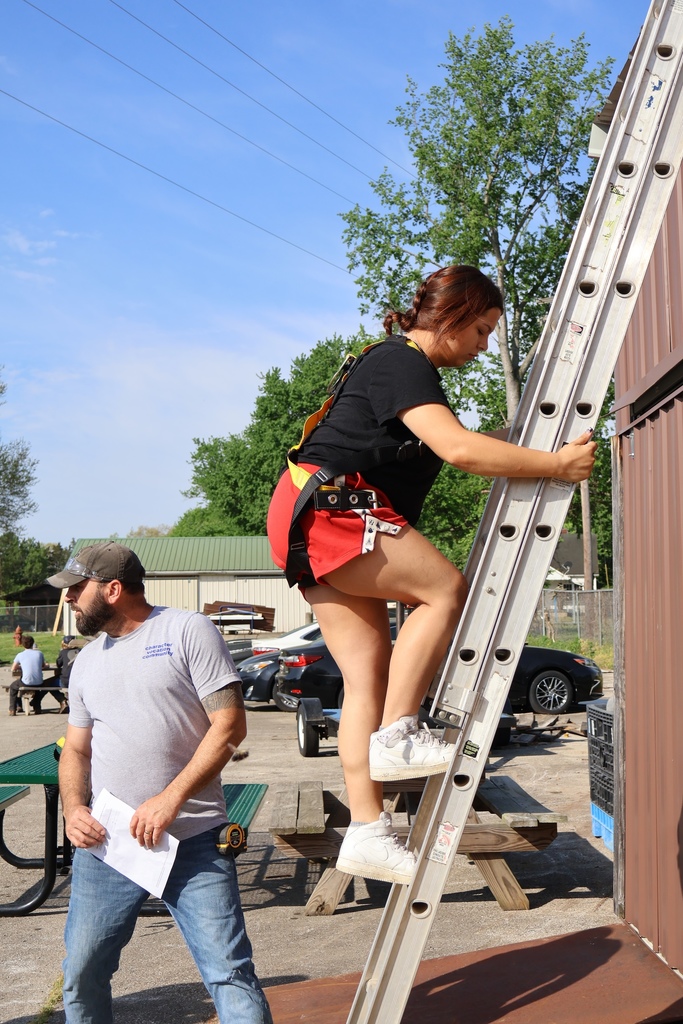 student climbing ladder