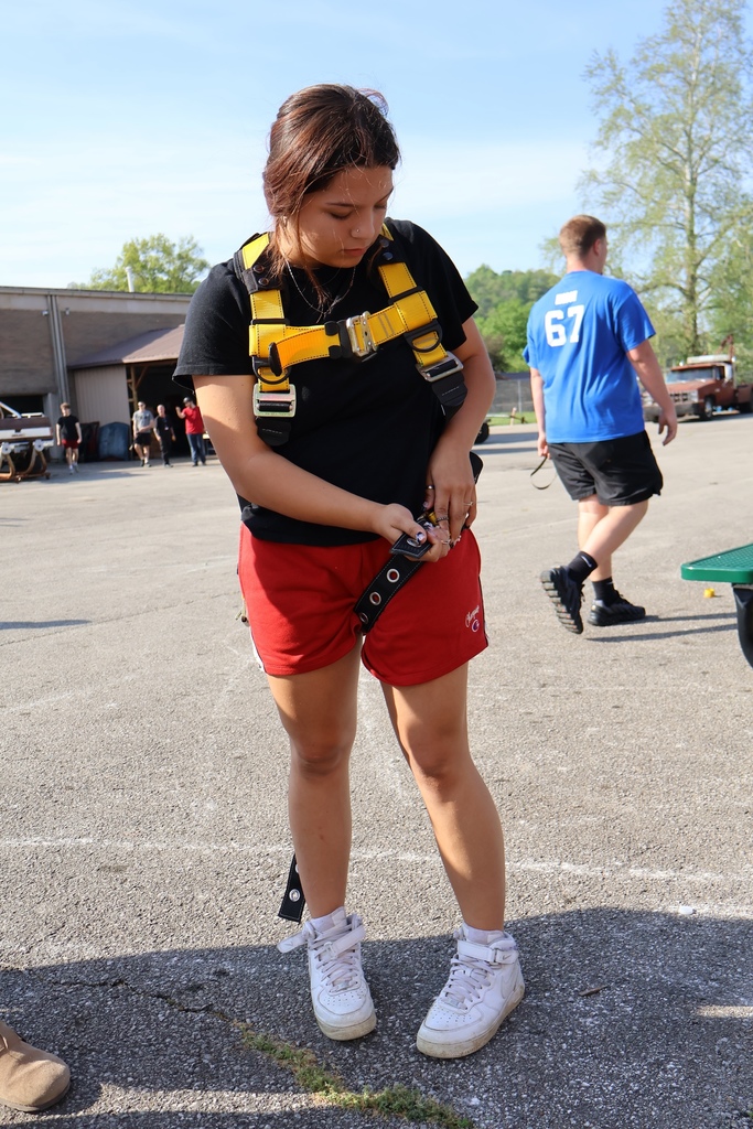 student attaching harness