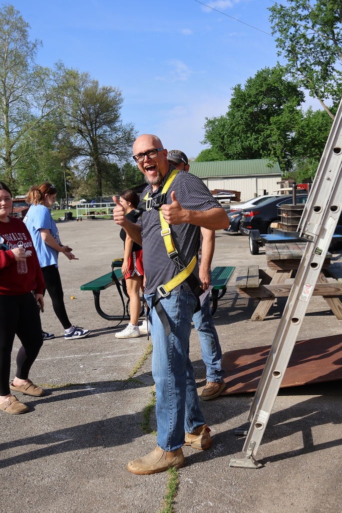 counselor giving thumbs up after climbing down ladder