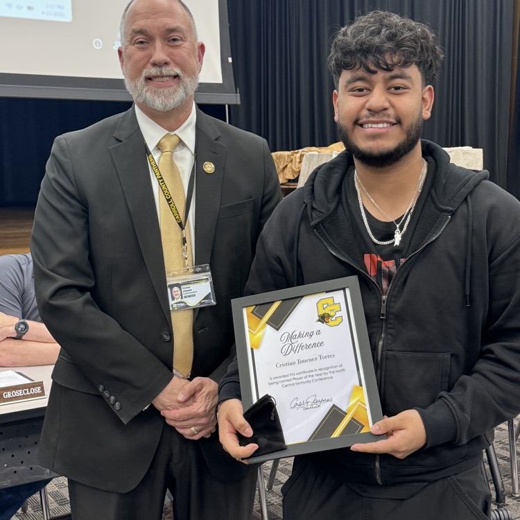 student getting award from superintendent
