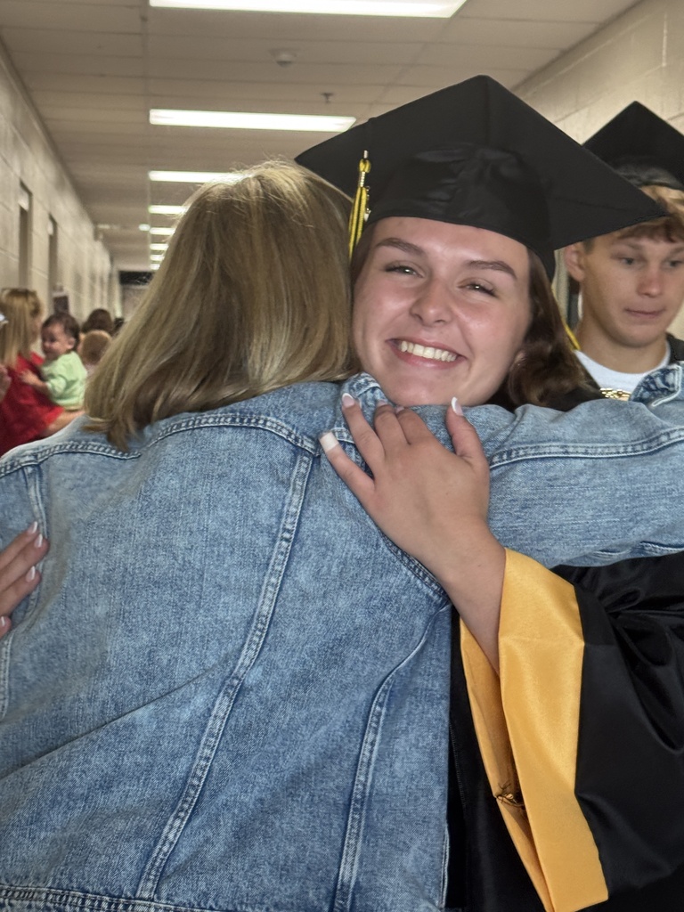 Senior getting hug from former teacher