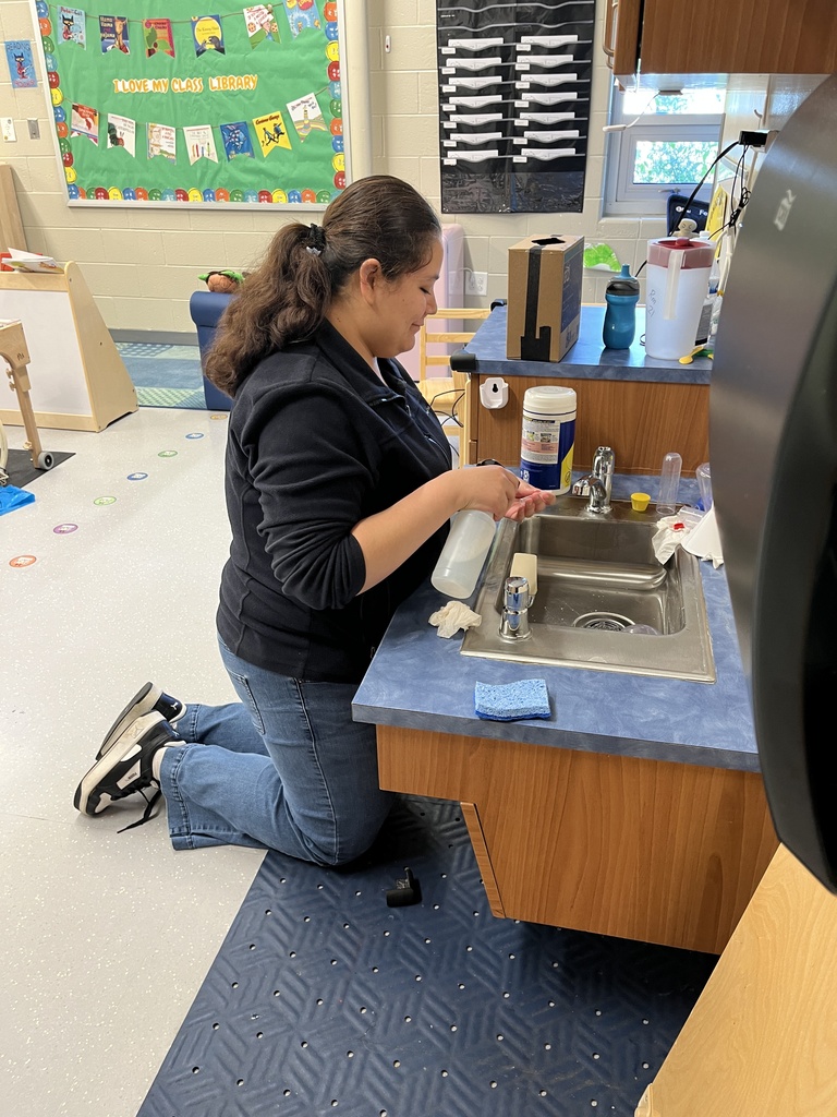 student cleaning classroom
