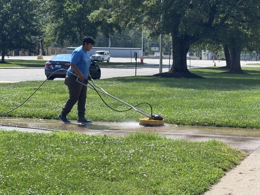 man power washing sidewalk