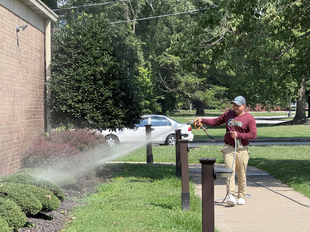 man power washing building