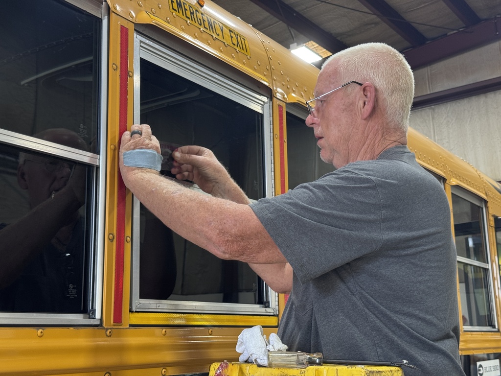 Putting stickers on school bus window