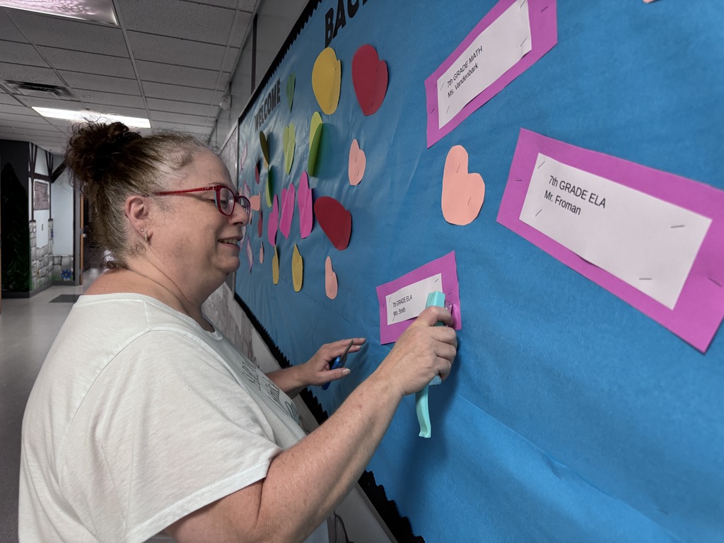 Teacher working on bulletin board