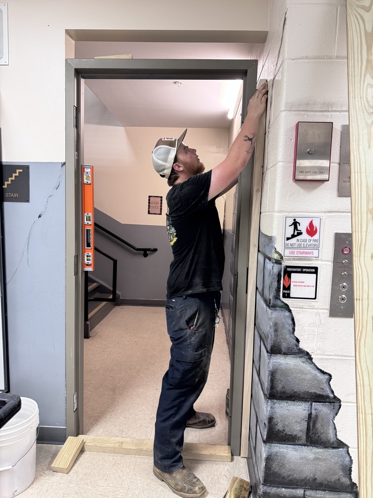 Maintenance staff installing door frame