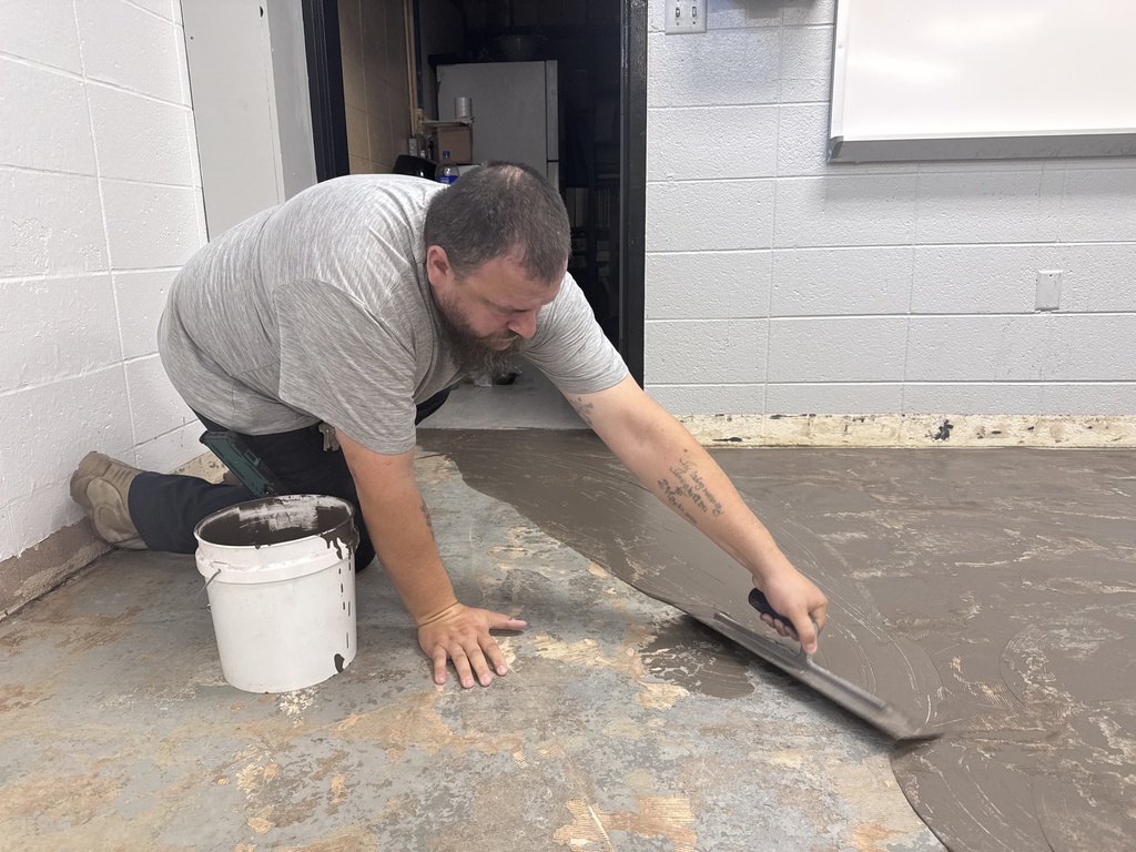 Applying glue for new flooring