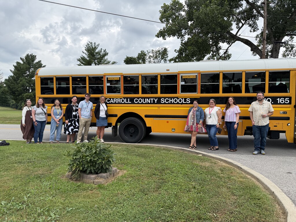New teachers in front of school bus