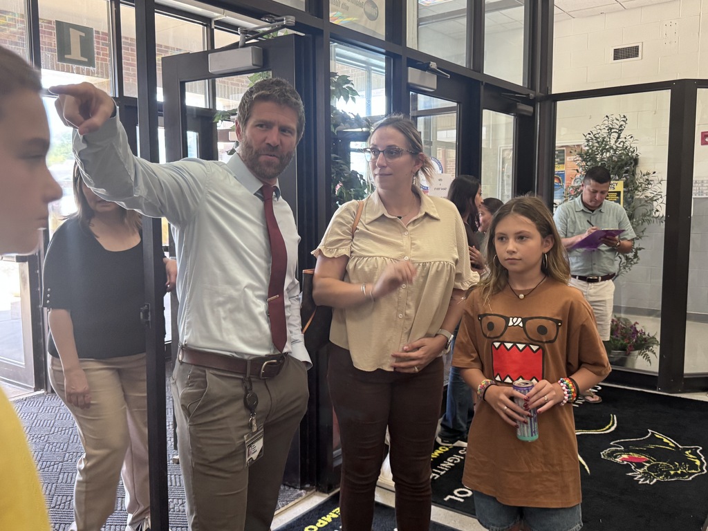 Principal talking with family at open house