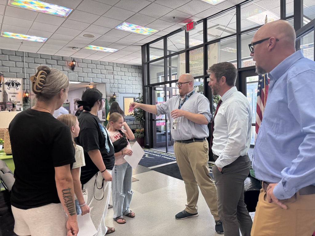 Administrators greeting students