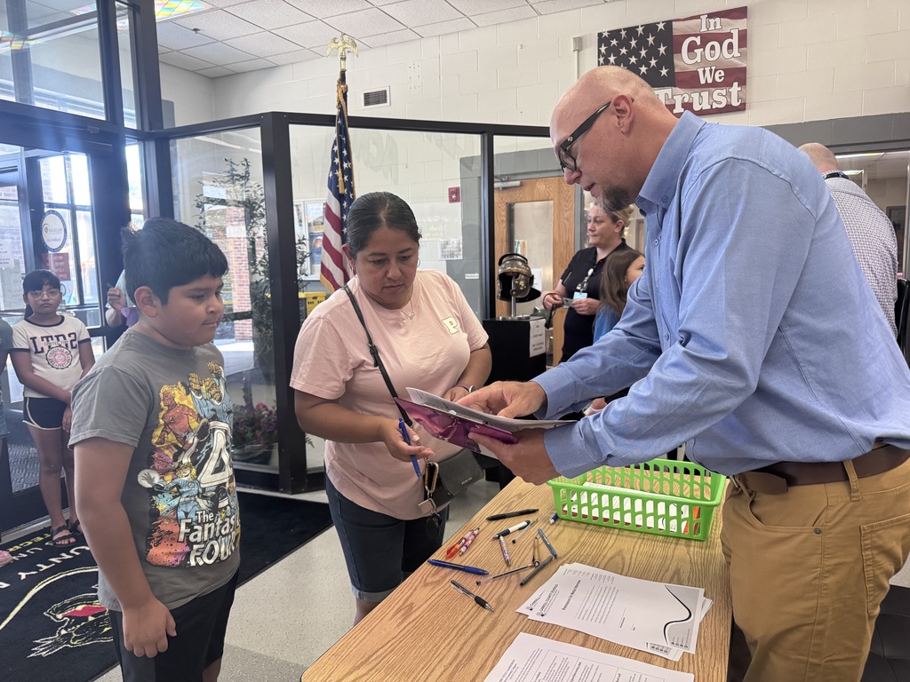 Assistant principal talking with family at open house