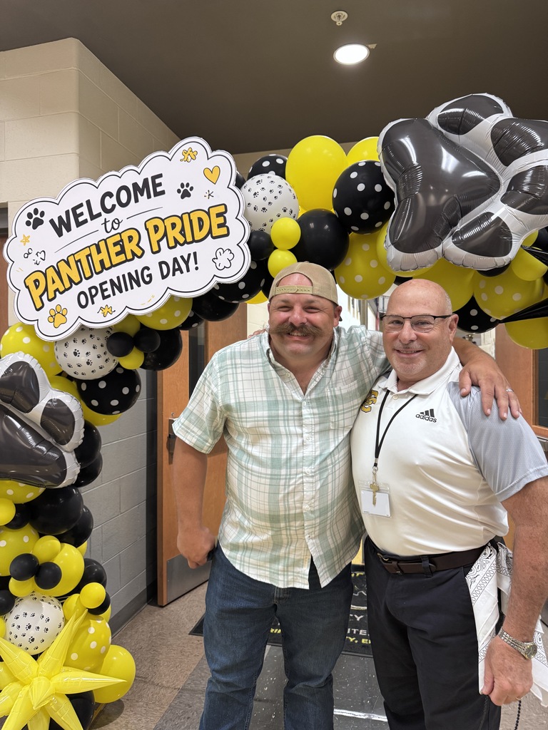 Board member and superintendent celebrating opening day
