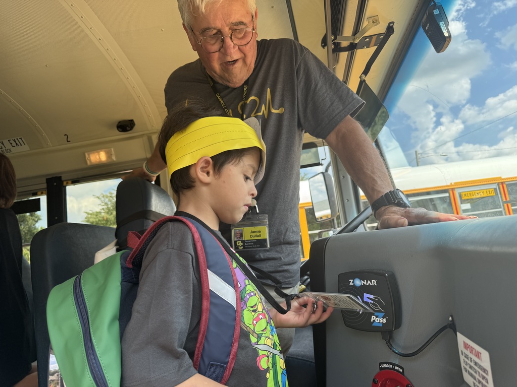 Student using badge on school bus