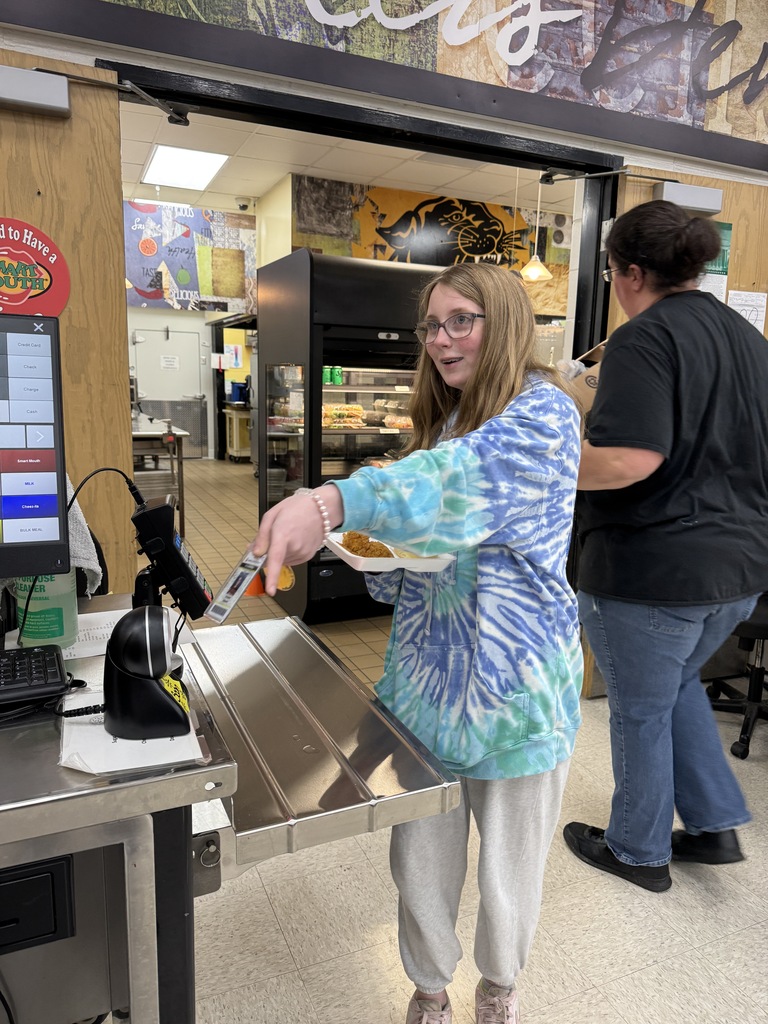 student using badge in cafeteria