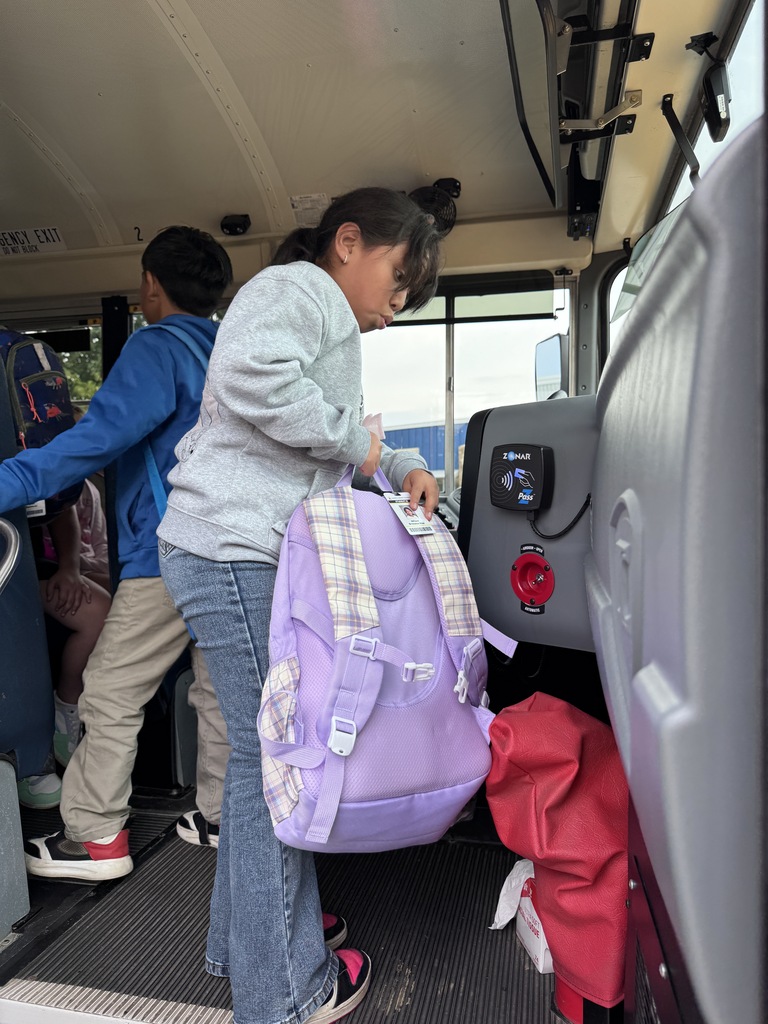 Student scanning badge on school bus