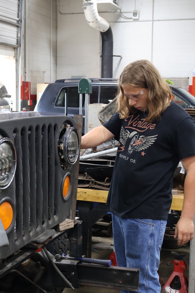 student working on car