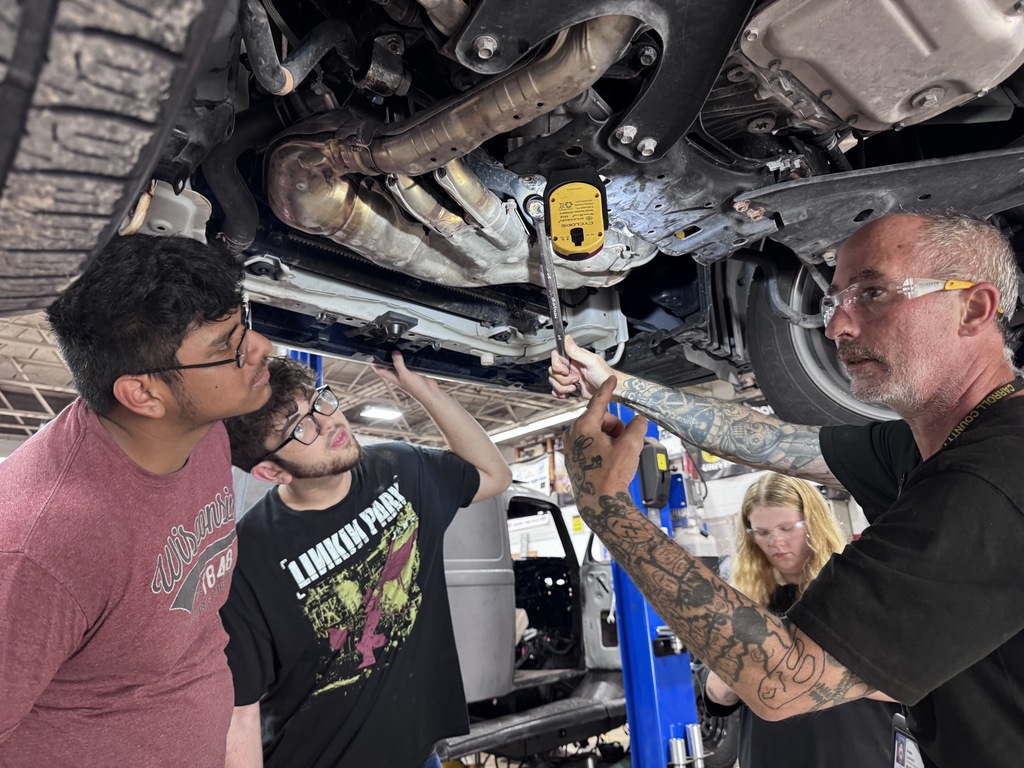 students working on car