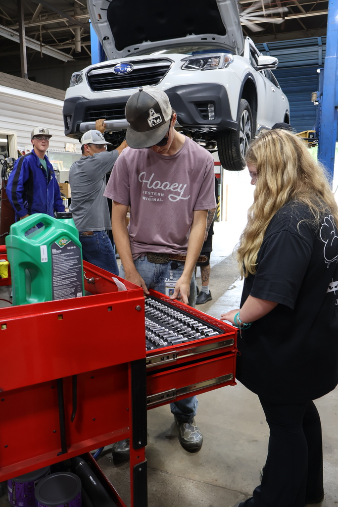 students working on car