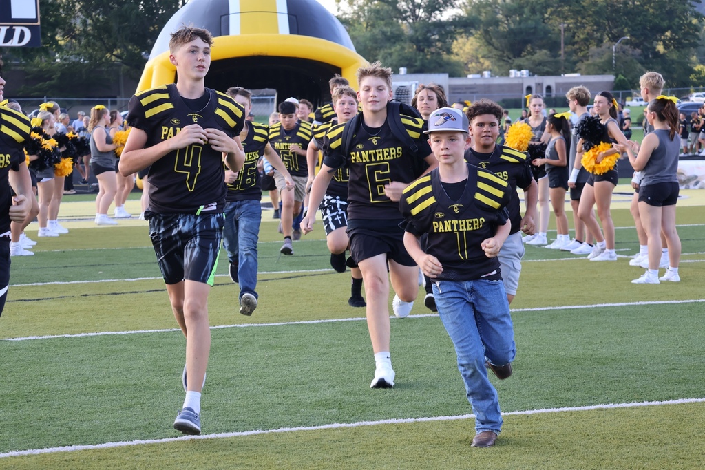 Football players running onto field