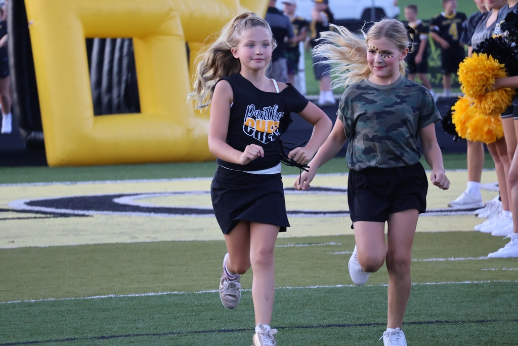 Girls running onto football field
