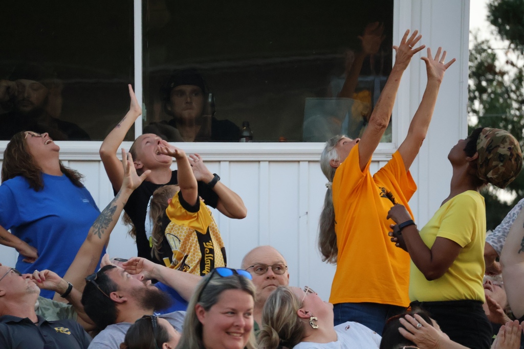 Crowd trying to catch T-shirt