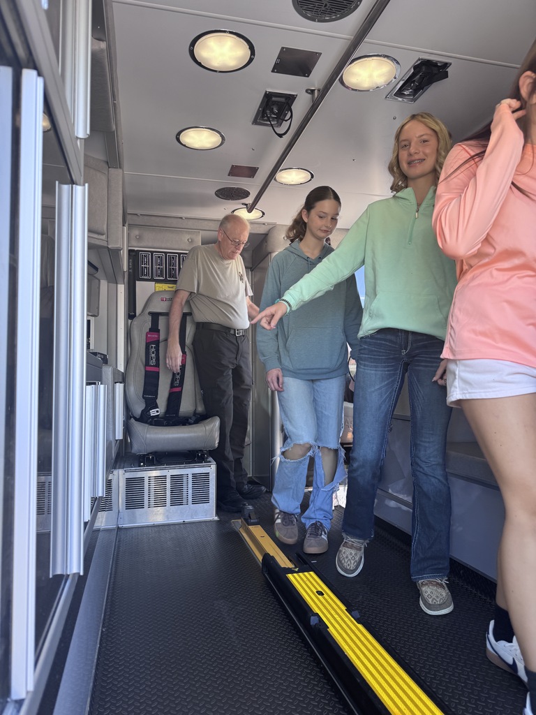 Students walking through ambulance