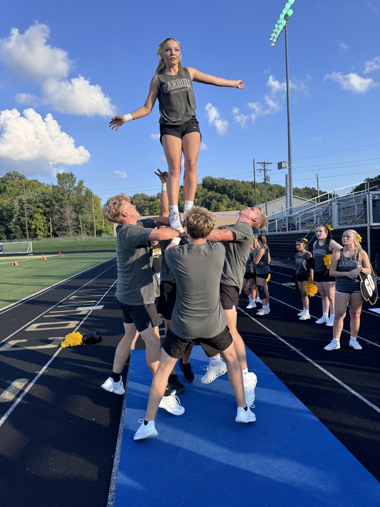 Cheerleaders preparing for a stunt