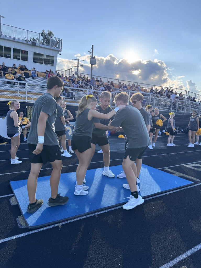 Cheerleaders preparing for stunt