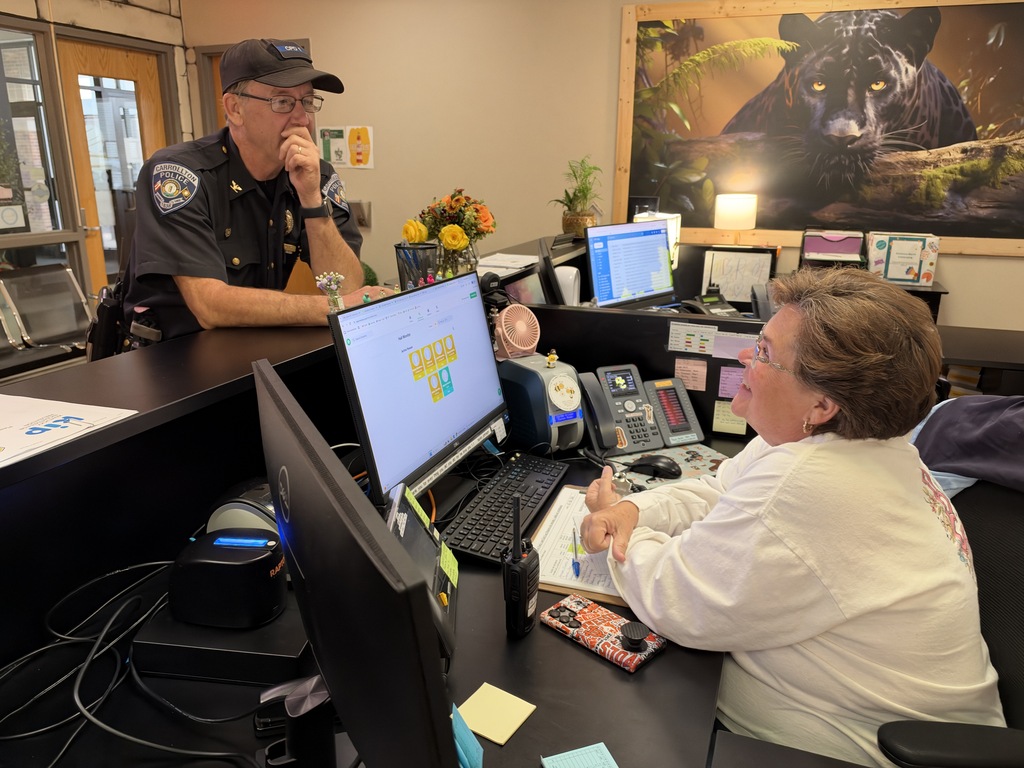Officer talking to secretary