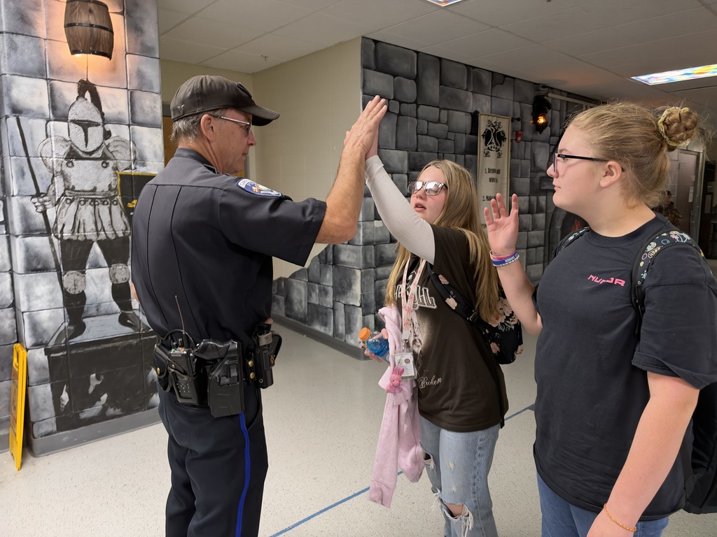 Officer giving high five to student