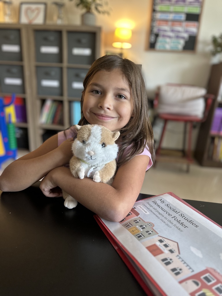 student holding stuffed animal