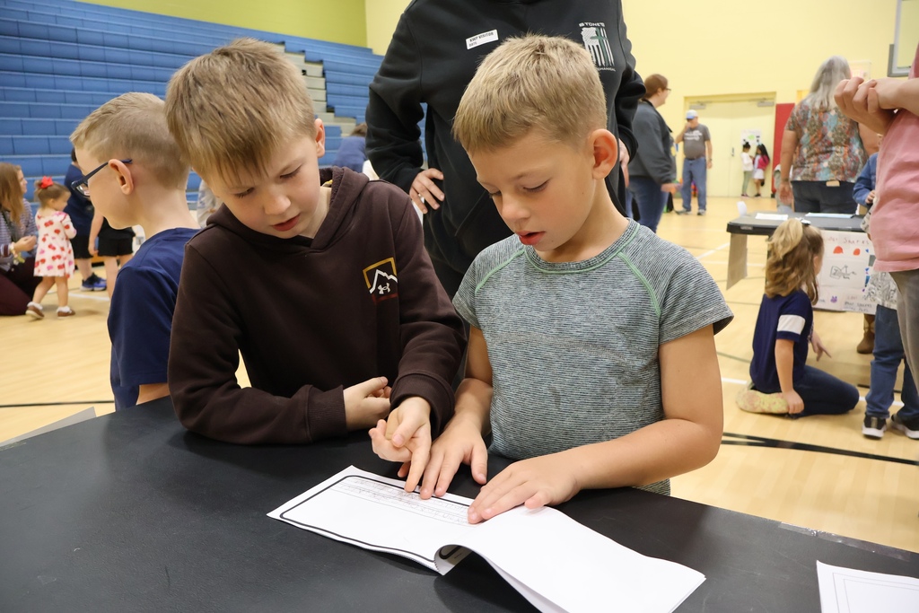 students looking at book