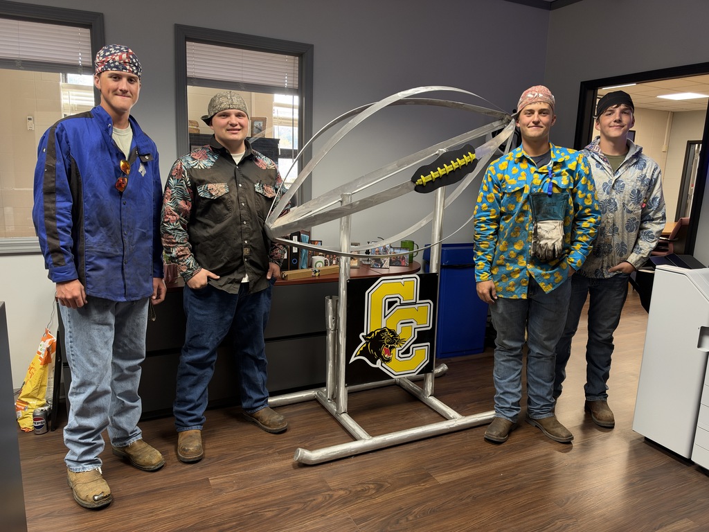 welding students with football