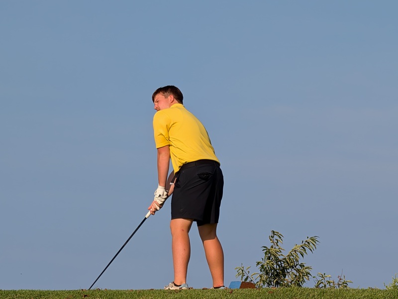 student playing golf