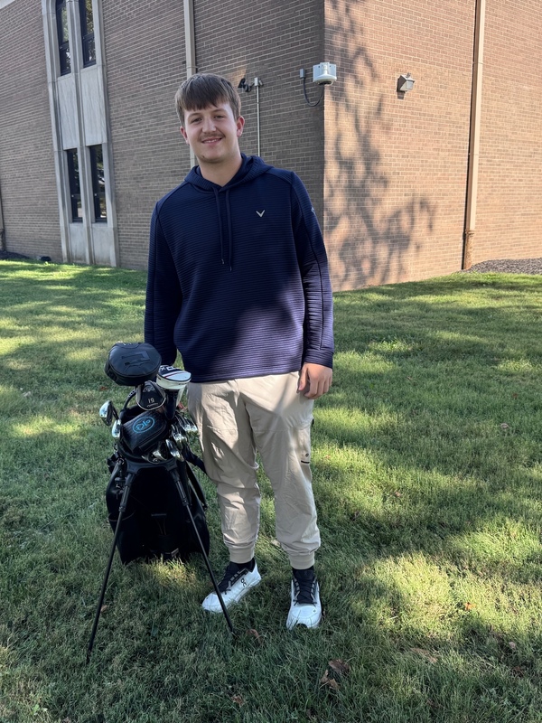 student playing golf