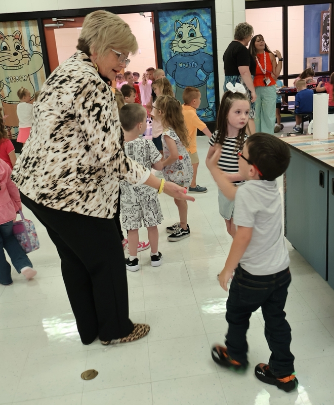 Superintendent giving high five to student
