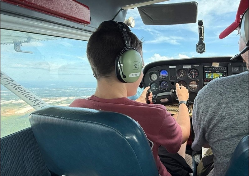 student flying plane