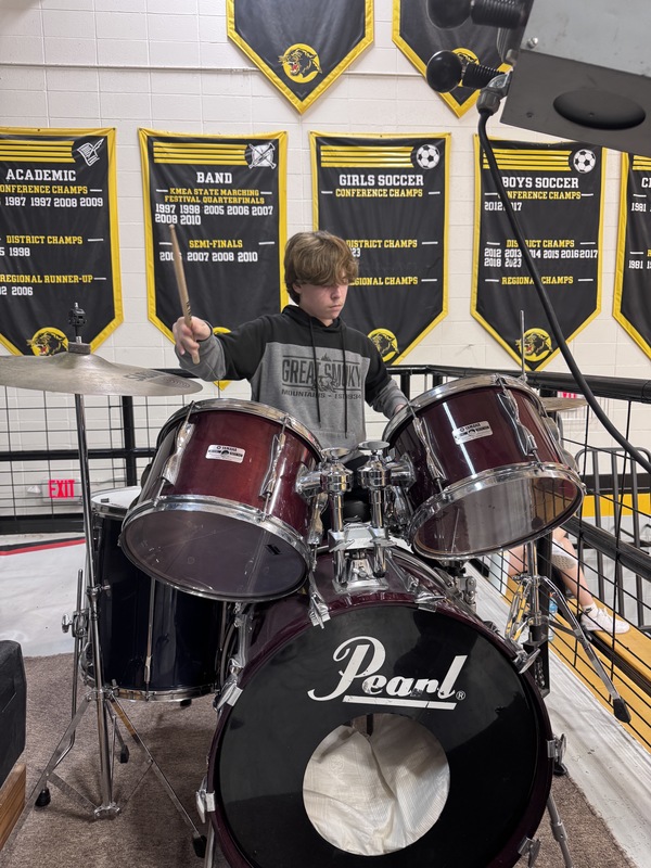 student playing drums